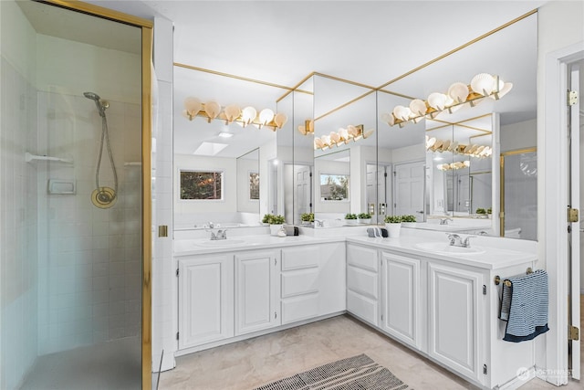 bathroom with a shower with door and vanity