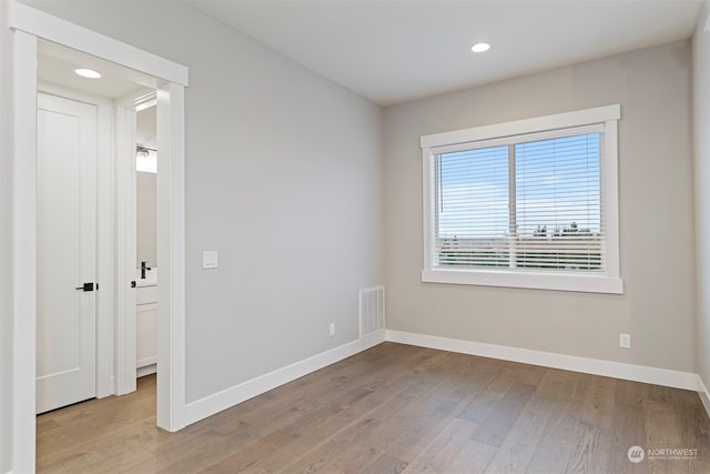 spare room featuring light wood-type flooring