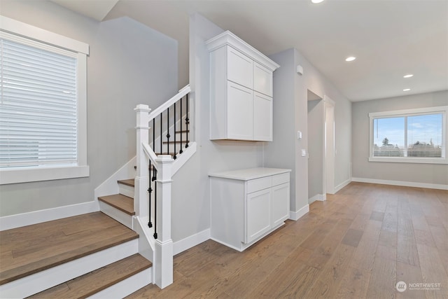 stairway featuring hardwood / wood-style flooring