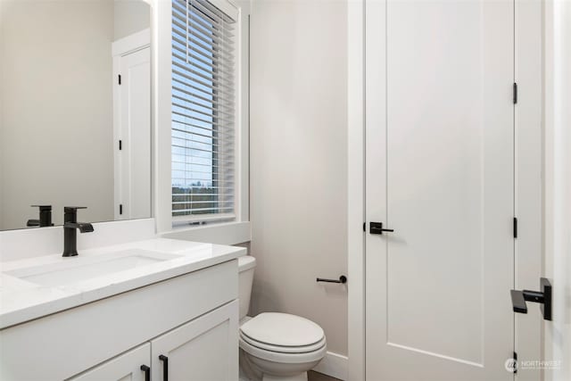 bathroom featuring vanity and toilet