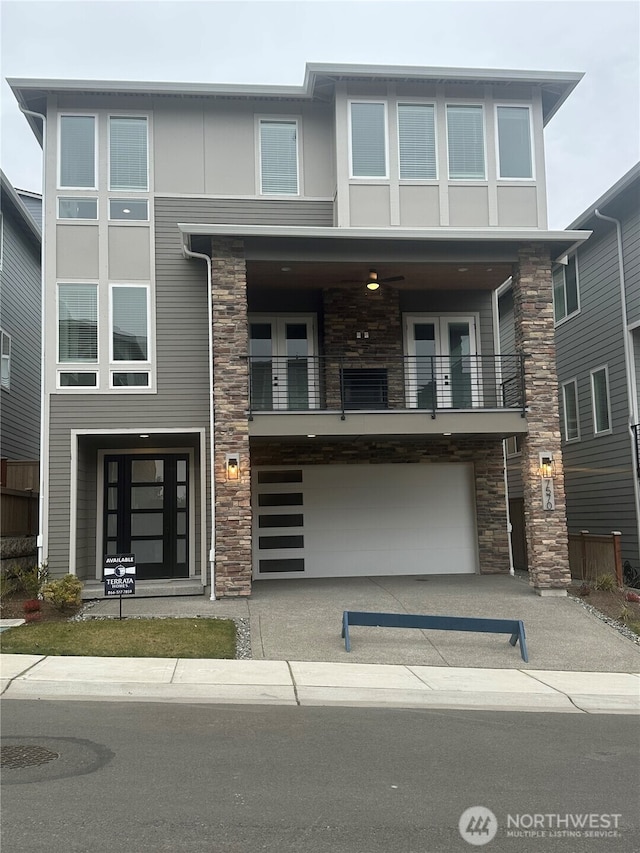 view of front facade with a garage and a balcony