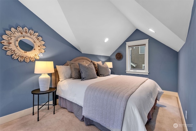 bedroom with vaulted ceiling and light carpet