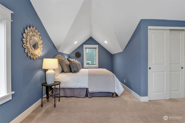 bedroom with light carpet and lofted ceiling