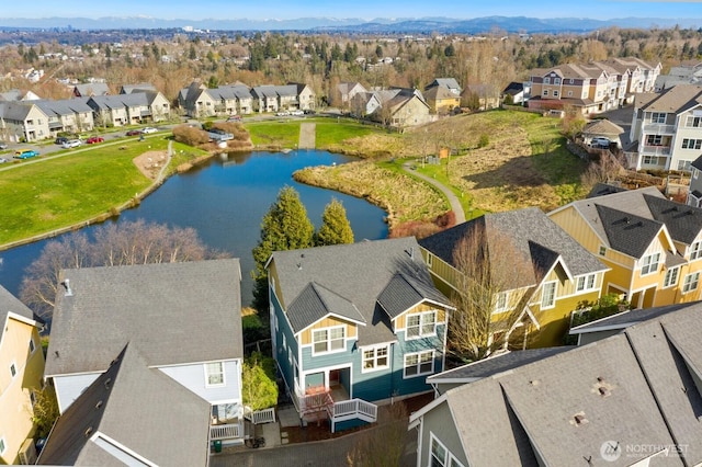 drone / aerial view featuring a residential view and a water view