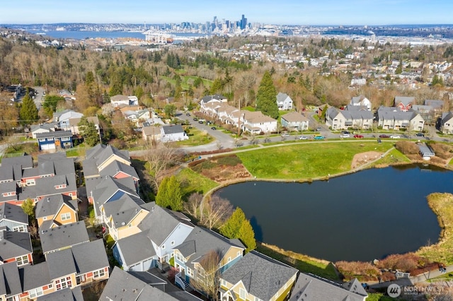 drone / aerial view with a residential view and a water view