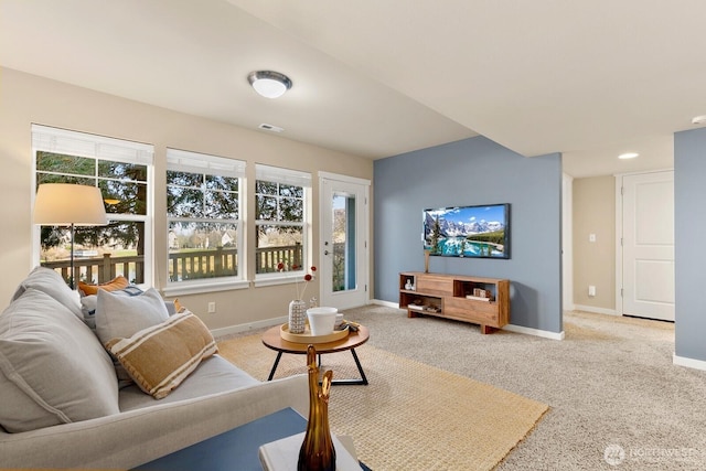 living area with recessed lighting, baseboards, visible vents, and light carpet