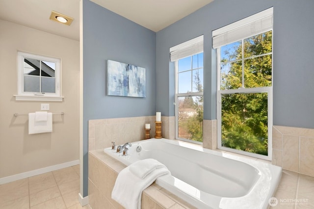 full bath with tile patterned floors, baseboards, and a garden tub