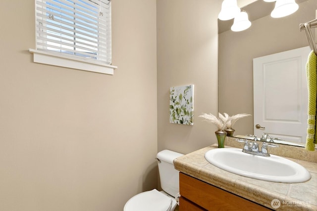 bathroom with toilet and vanity