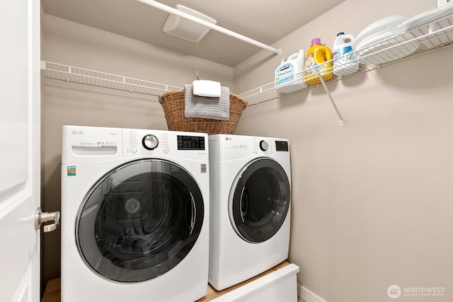 washroom with laundry area and washer and dryer