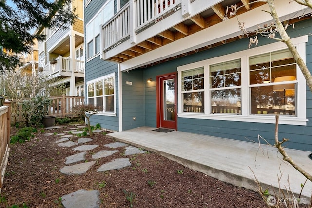 doorway to property featuring fence and a patio area