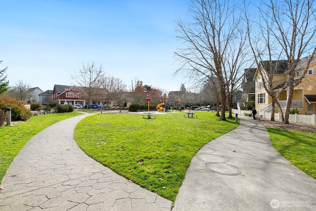 surrounding community with a residential view and a lawn