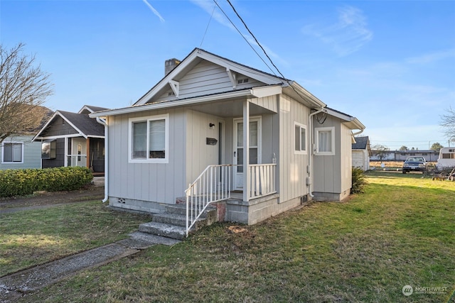 bungalow-style home with a front lawn