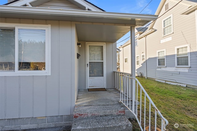 entrance to property with a lawn