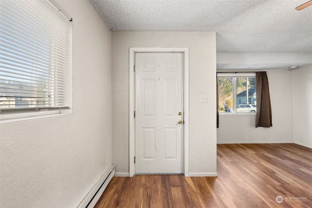 foyer with hardwood / wood-style flooring and a textured ceiling