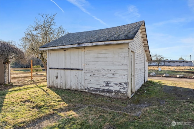 view of outbuilding with a lawn