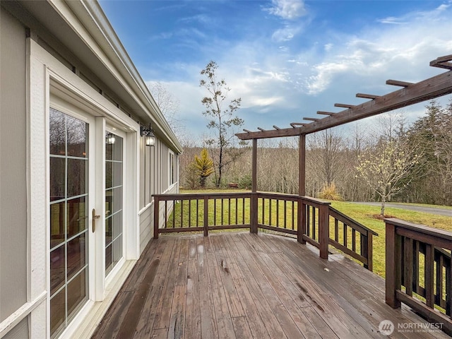 wooden terrace with a lawn