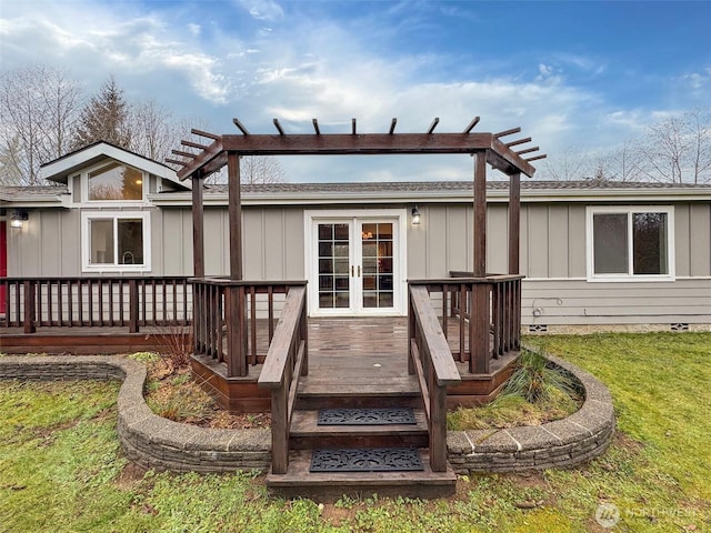 back of property with board and batten siding and a wooden deck