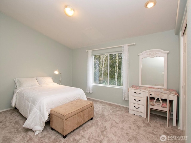 bedroom featuring light carpet and baseboards