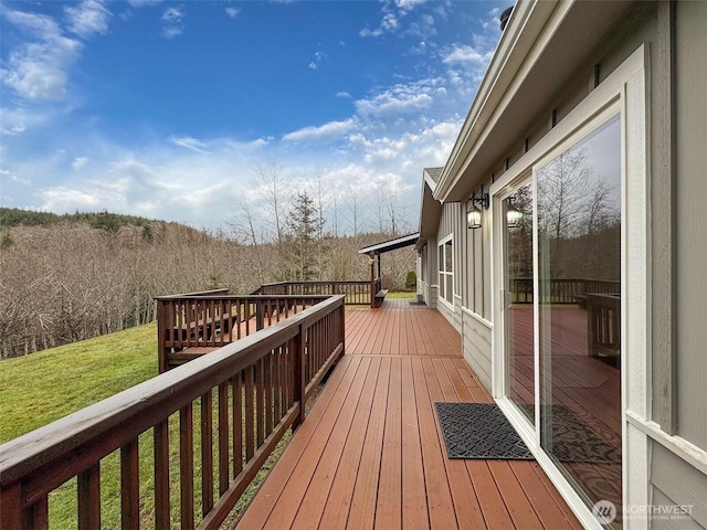 wooden terrace with a lawn