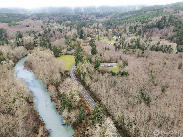 drone / aerial view featuring a view of trees