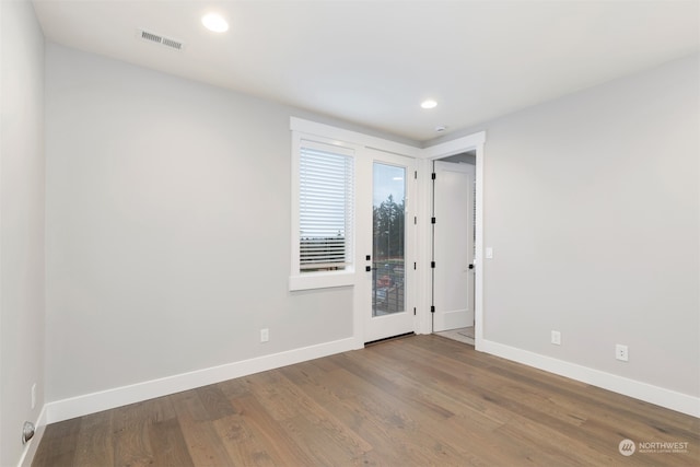 unfurnished room with wood-type flooring