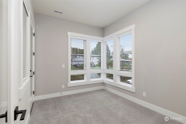 empty room featuring light colored carpet