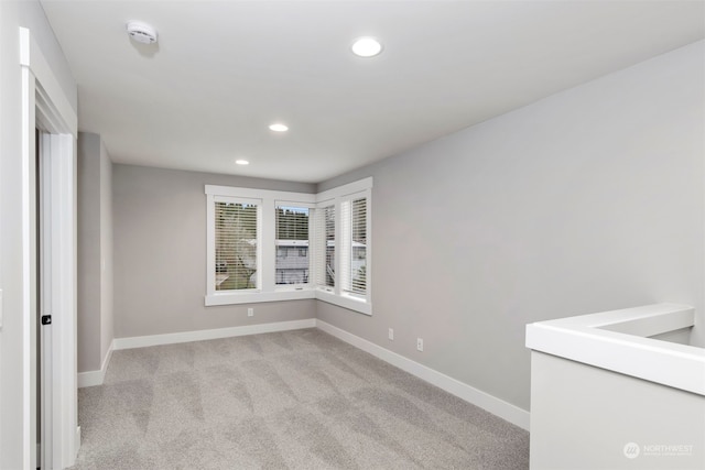 empty room featuring light colored carpet