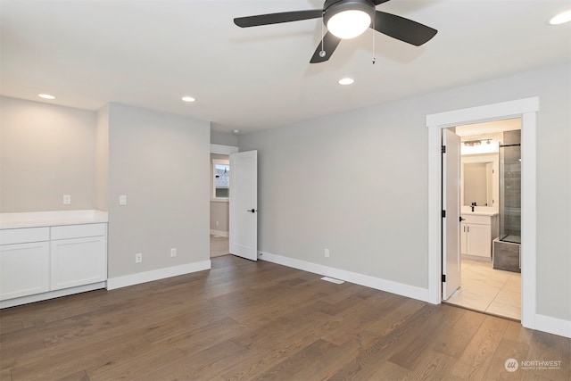 empty room with ceiling fan and light hardwood / wood-style flooring