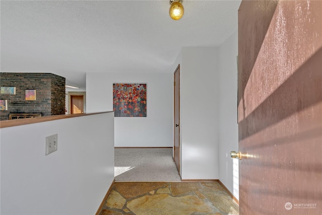 hallway featuring a textured ceiling