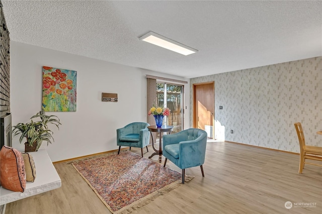 living area featuring hardwood / wood-style floors and a textured ceiling