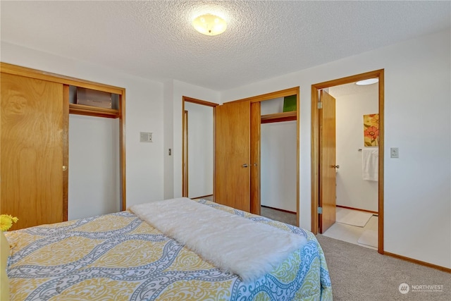 carpeted bedroom featuring a textured ceiling