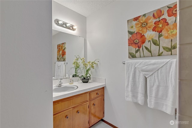 bathroom with vanity and a textured ceiling