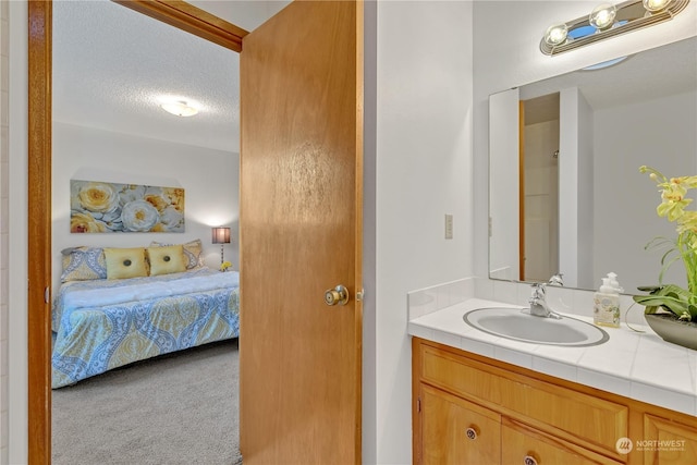 bathroom featuring vanity and a textured ceiling