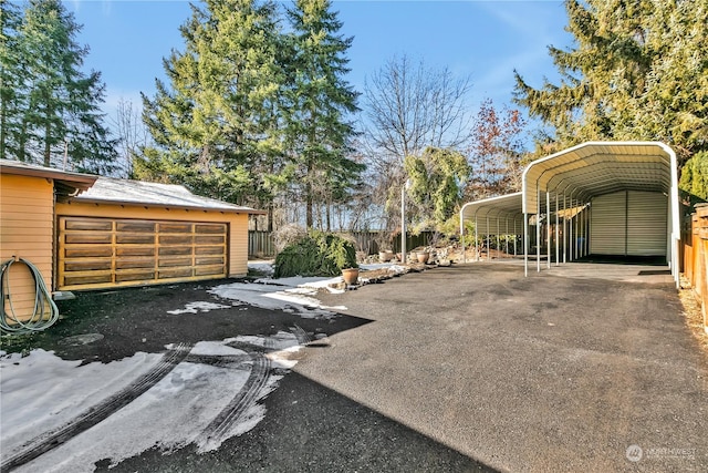 view of car parking featuring a carport and a garage