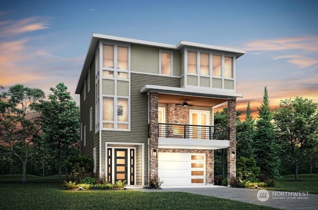 contemporary house with ceiling fan, a garage, and a balcony