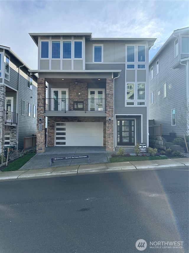 view of front facade with stone siding and an attached garage