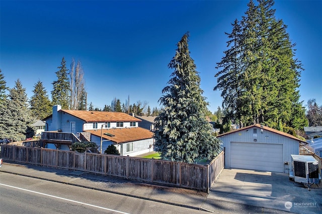 view of front of property with a garage and an outdoor structure