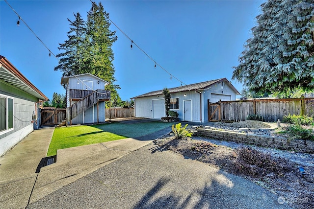 exterior space featuring a storage unit, a patio, and a lawn