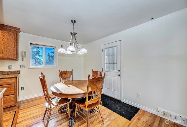 dining room featuring a chandelier and light hardwood / wood-style floors