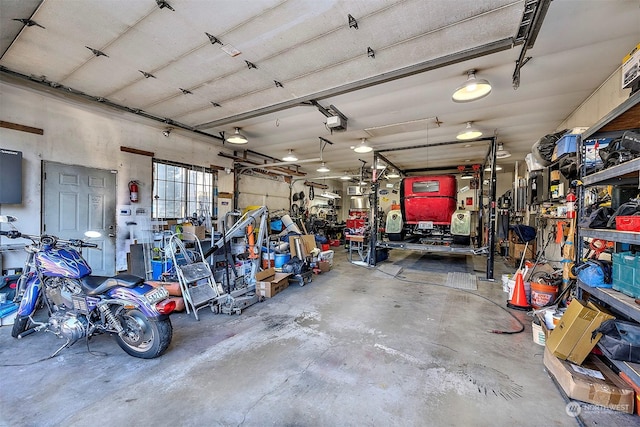 garage featuring a garage door opener and a workshop area