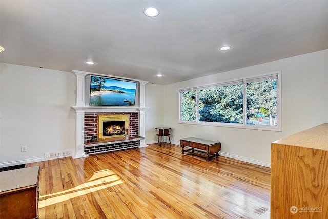 living room with hardwood / wood-style floors and a fireplace