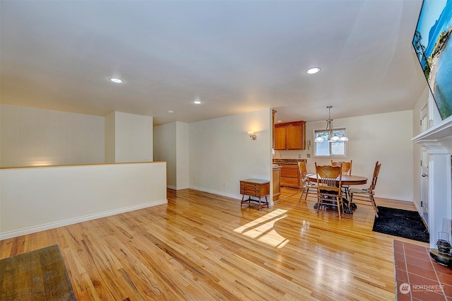 living room with a chandelier and light wood-type flooring