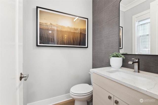 bathroom with vanity, tile walls, decorative backsplash, and toilet