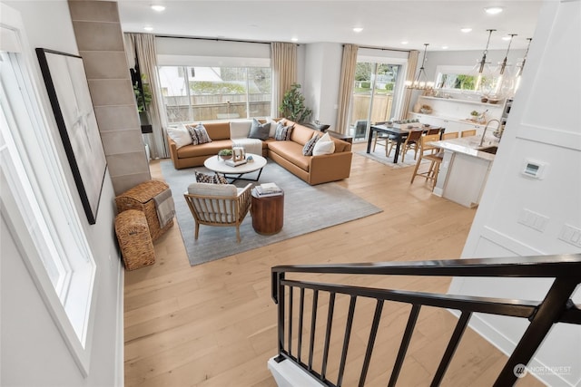 living room featuring an inviting chandelier and light hardwood / wood-style floors