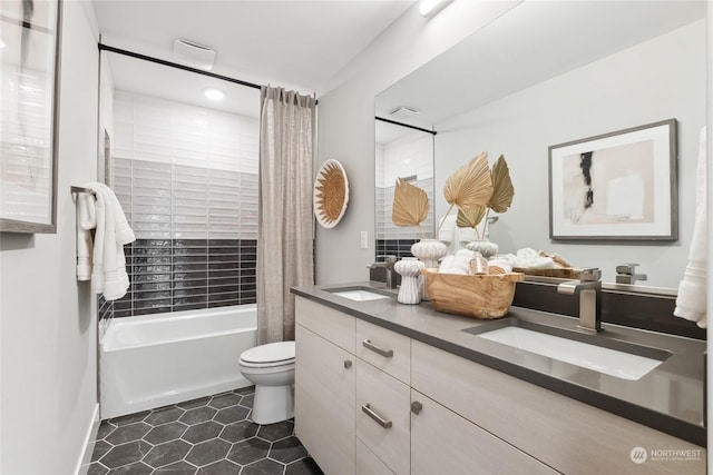 full bathroom with tile patterned floors, vanity, toilet, and shower / tub combo