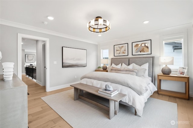 bedroom with ornamental molding and light wood-type flooring