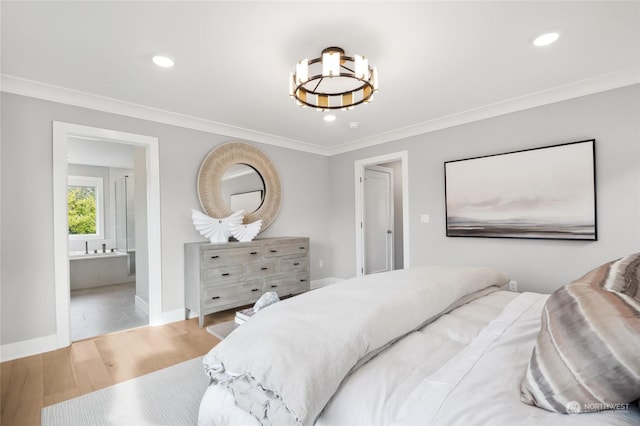 bedroom featuring connected bathroom, hardwood / wood-style floors, and ornamental molding