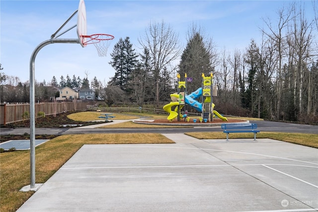 view of basketball court featuring a playground