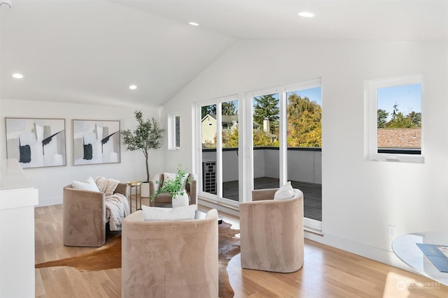 dining space featuring vaulted ceiling and light hardwood / wood-style floors