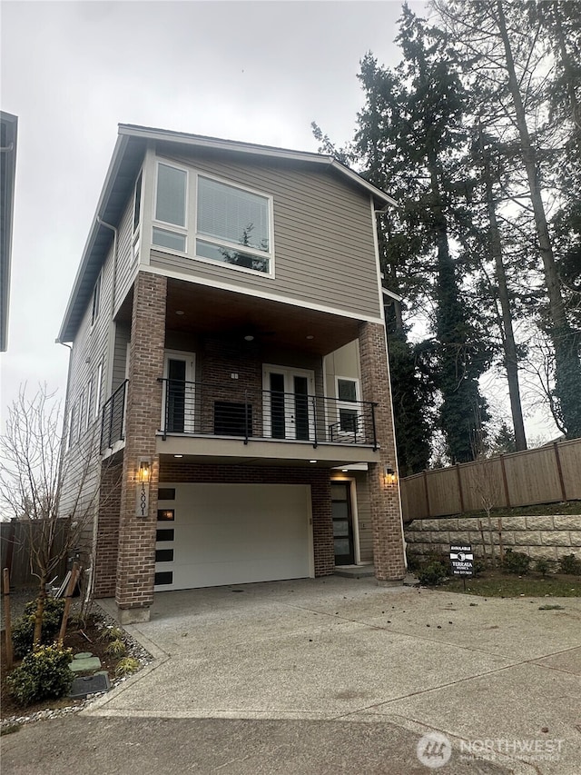 contemporary home featuring a balcony and a garage